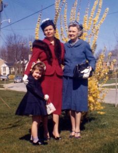 Mom, Nana and I with Easter hats, by the forsythia, in 1961
